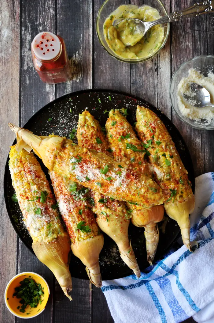 Roasted corn on the cob coated w/ homemade aioli, paprika, Parmesan cheese and parsley, this Caribbean-style corn will change the way you eat corn forever.