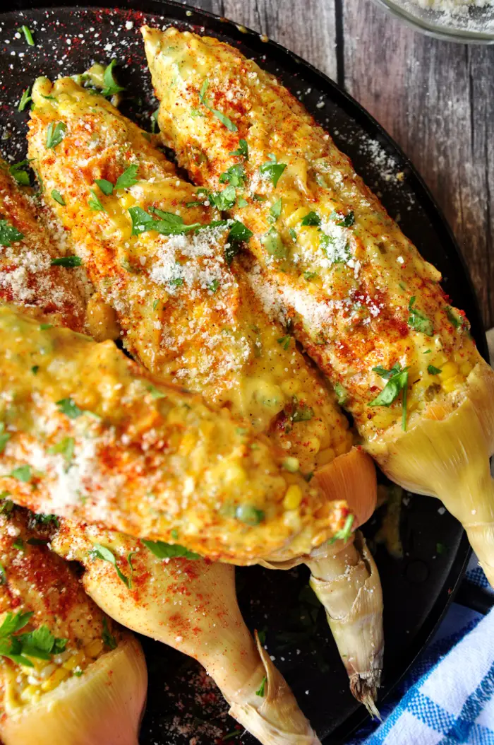 Roasted corn on the cob coated w/ homemade aioli, paprika, Parmesan cheese and parsley, this Caribbean-style corn will change the way you eat corn forever.