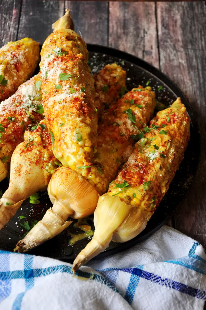 Roasted corn on the cob coated w/ homemade aioli, paprika, Parmesan cheese and parsley, this Caribbean-style corn will change the way you eat corn forever.