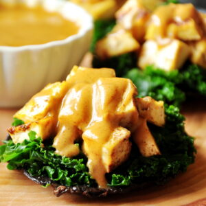 Stuffed portabella mushrooms with baked tofu and crunchy kale drizzled with a creamy cajun dressing for the win! They are vegan and gluten-free!