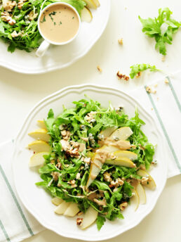 Topped with blue cheese and chopped walnuts, this four-ingredient arugula pear salad drizzled with tahini dressing is so quick to throw together, yet the combination of sweet and salty flavors and crunchy and soft textures proves that simple can be phenomenal.