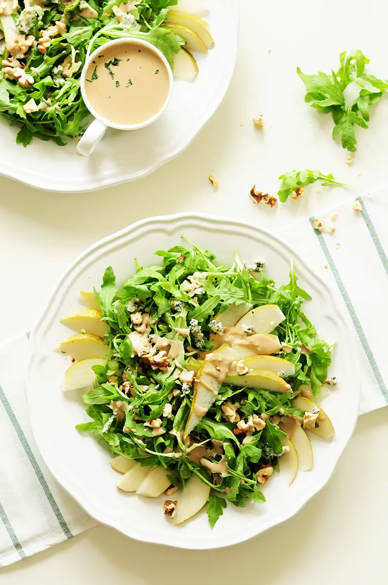 Topped with blue cheese and chopped walnuts, this four-ingredient arugula pear salad drizzled with tahini dressing is so quick to throw together, yet the combination of sweet and salty flavors and crunchy and soft textures proves that simple can be phenomenal.