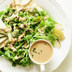 Topped with blue cheese and chopped walnuts, this four-ingredient arugula pear salad drizzled with tahini dressing is so quick to throw together, yet the combination of sweet and salty flavors and crunchy and soft textures proves that simple can be phenomenal.