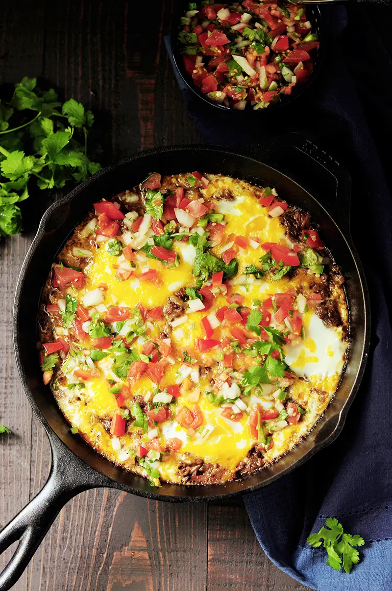 Baked eggs in barbacoa beef and topped with cheese, this is a perfect way to turn leftover barbacoa beef into an amazing brunch in just 20 minutes.
