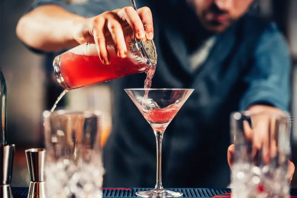 Bartender making cocktail with vodka