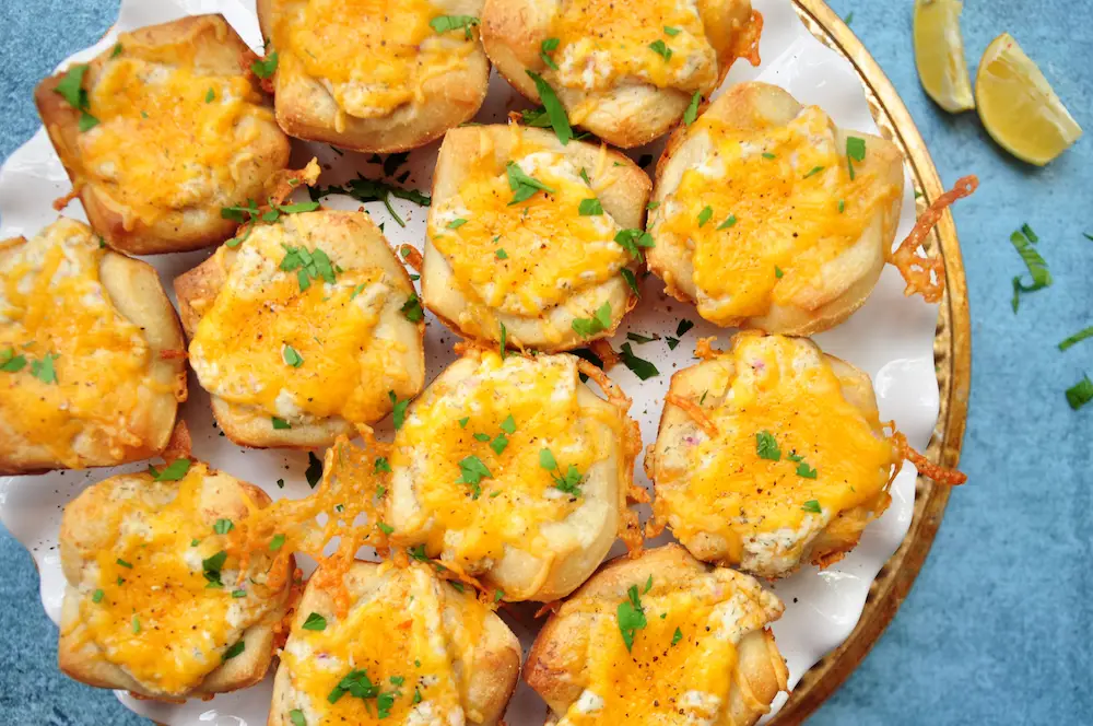 Cheese, crab, herbs and lemon, plus a pizza crust shaped into muffin cups, these cheesy crab appetizers are super fun and quick to make.