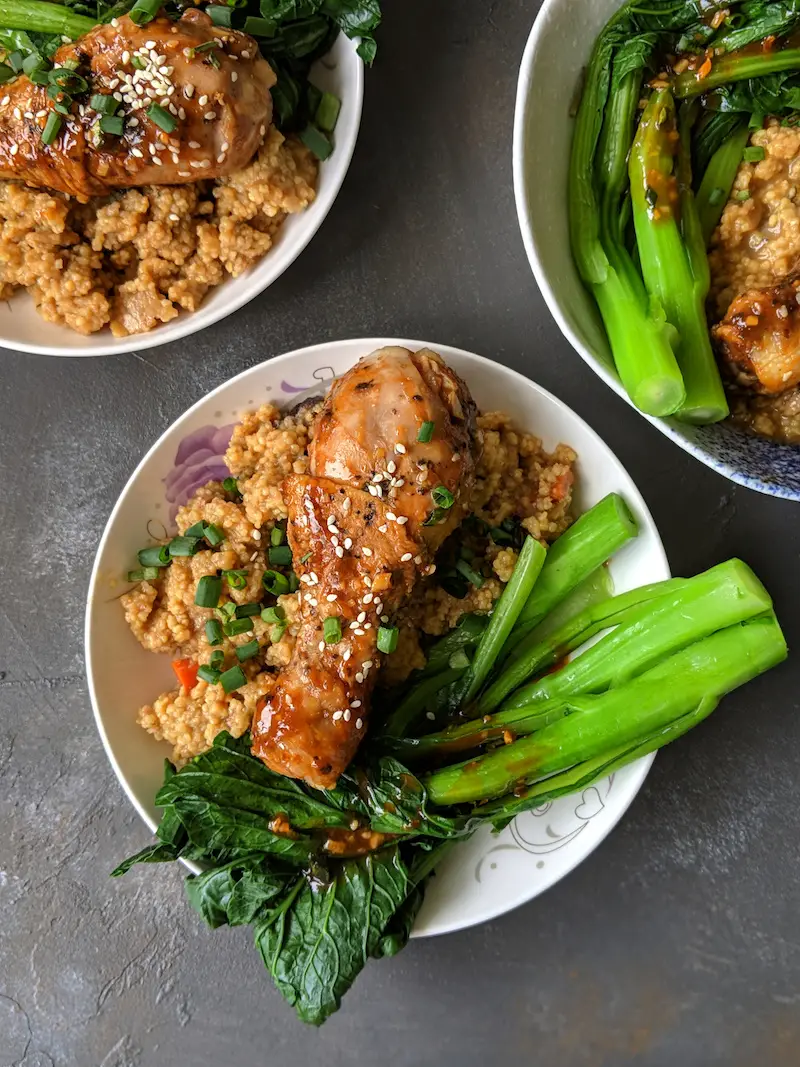 Spicy and sticky chicken drumsticks with Chinese kale and millet