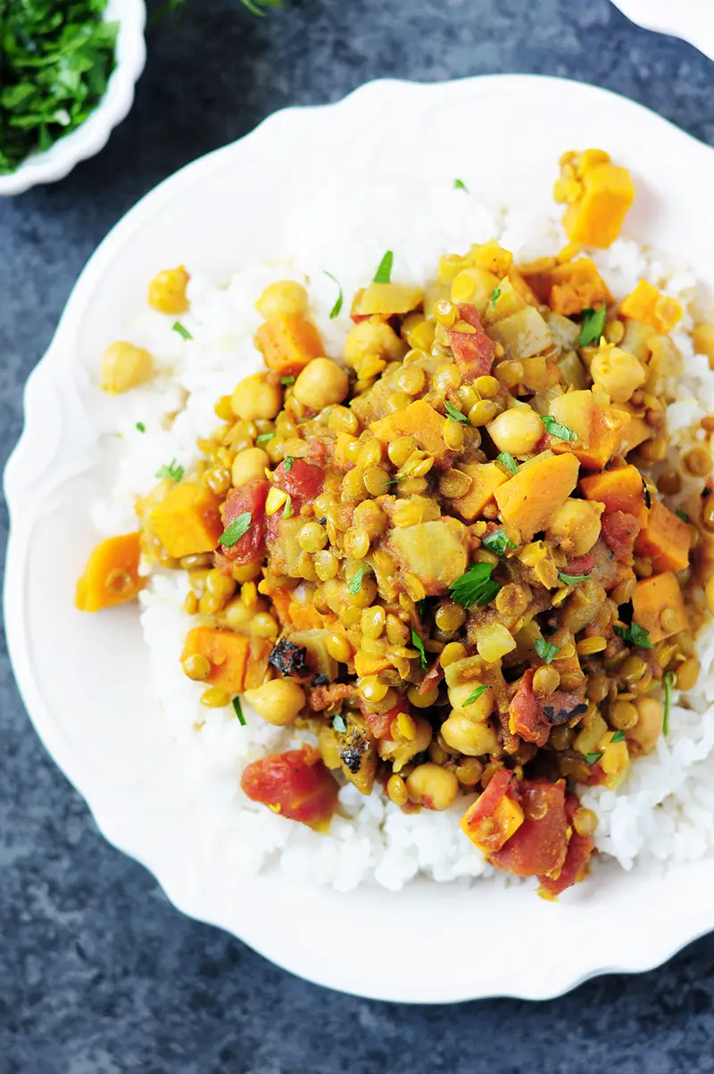 Curried lentils cooked with sweet potatoes, fire-roasted tomatoes chickpeas, this vegan and gluten-free dish is high in protein and big on flavor.