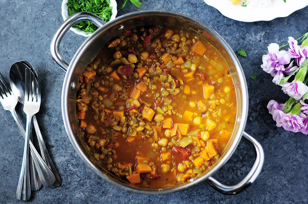 Curried lentils cooked with sweet potatoes, fire-roasted tomatoes chickpeas, this vegan and gluten-free dish is high in protein and big on flavor.
