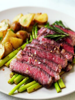 Sliced sous vide frozen steak with asparagus and potatoes