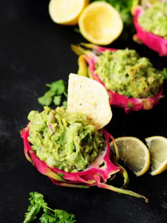 Surprise and delight your taste buds by combining dragon fruit with creamy avocado for a refreshing guacamole served individually in a dragon fruit shell.