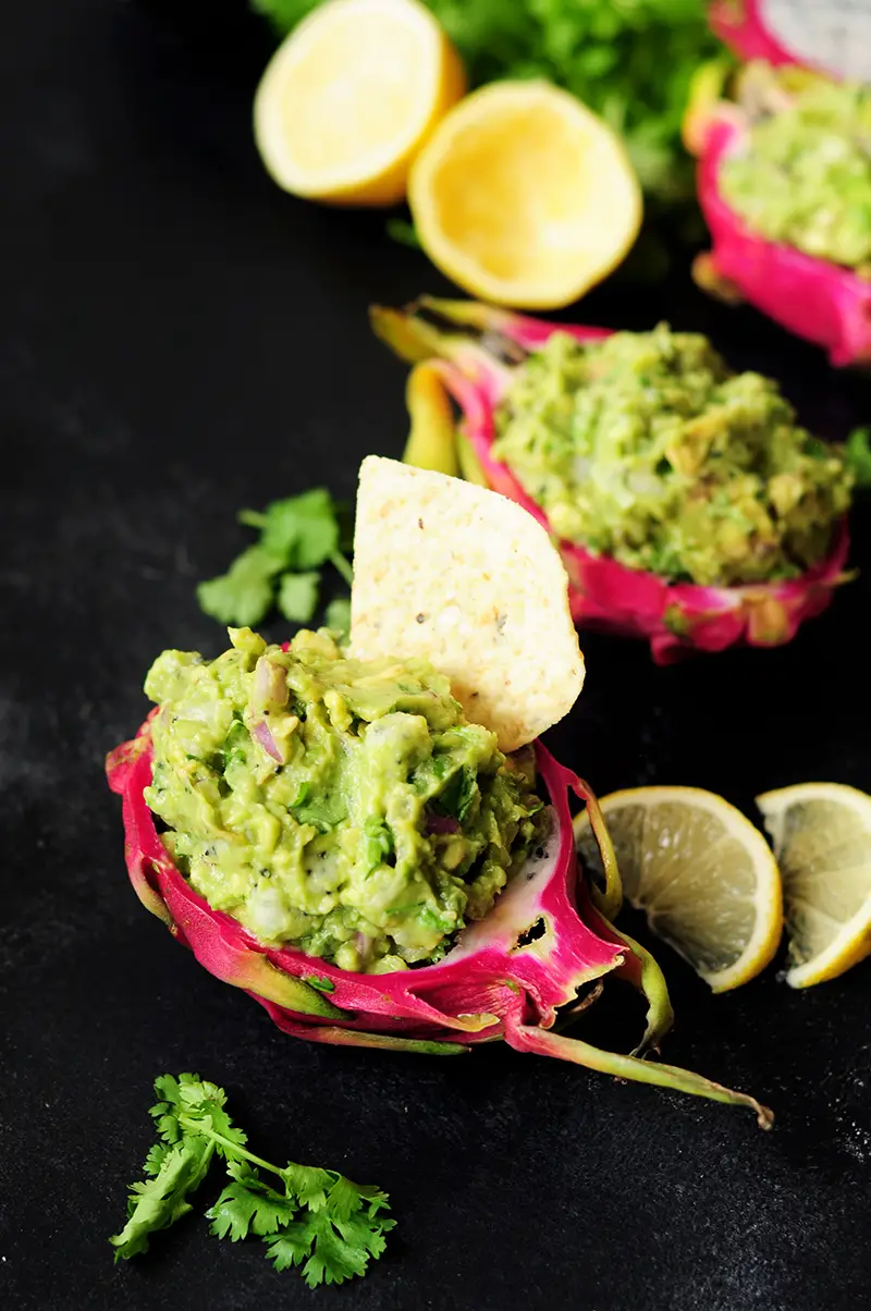 Surprise and delight your taste buds by combining dragon fruit with creamy avocado for a refreshing guacamole served individually in a dragon fruit shell.