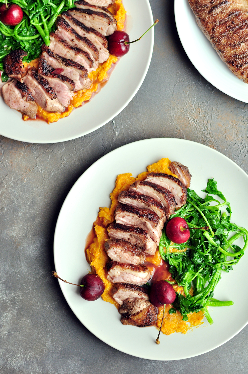 Five-Spice Sous Vide Duck Breast with Cherry Sauce served with mashed sweet potatoes and watercress