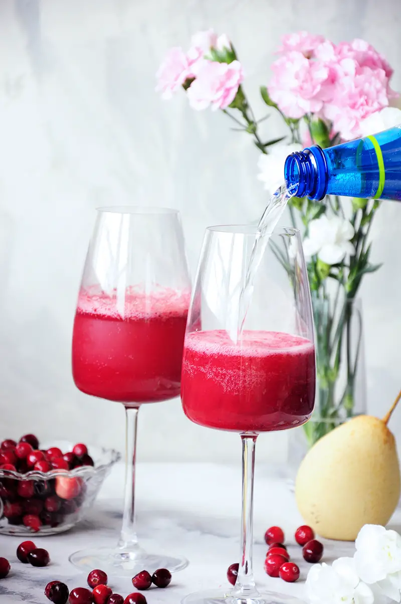 This fresh pear and cranberry mocktail is healthy, full of flavor, and lower in sugar than most fruity drinks. Perfect for the holidays or girls’ nights in.