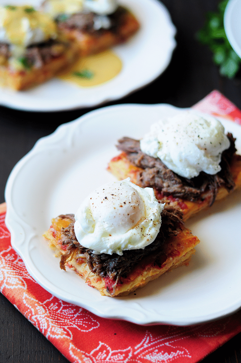 Drizzling the green chili hollandaise on eggs benedict