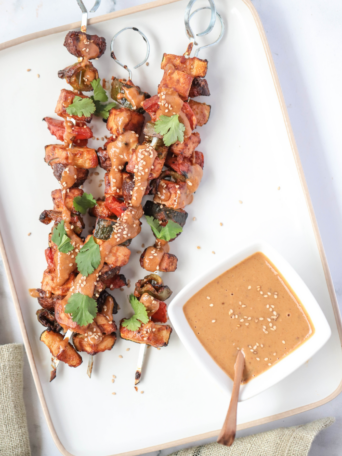 Grilled tofu skewers with veggies and a rich peanut sauce marinade — smoky, satisfying, and ready for the grill in under an hour.