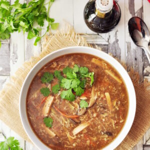 Authentic Chinese gluten-free hot and sour soup with loads of vegetables, tofu, and an egg cooked in a rich chicken broth or vegetable broth.