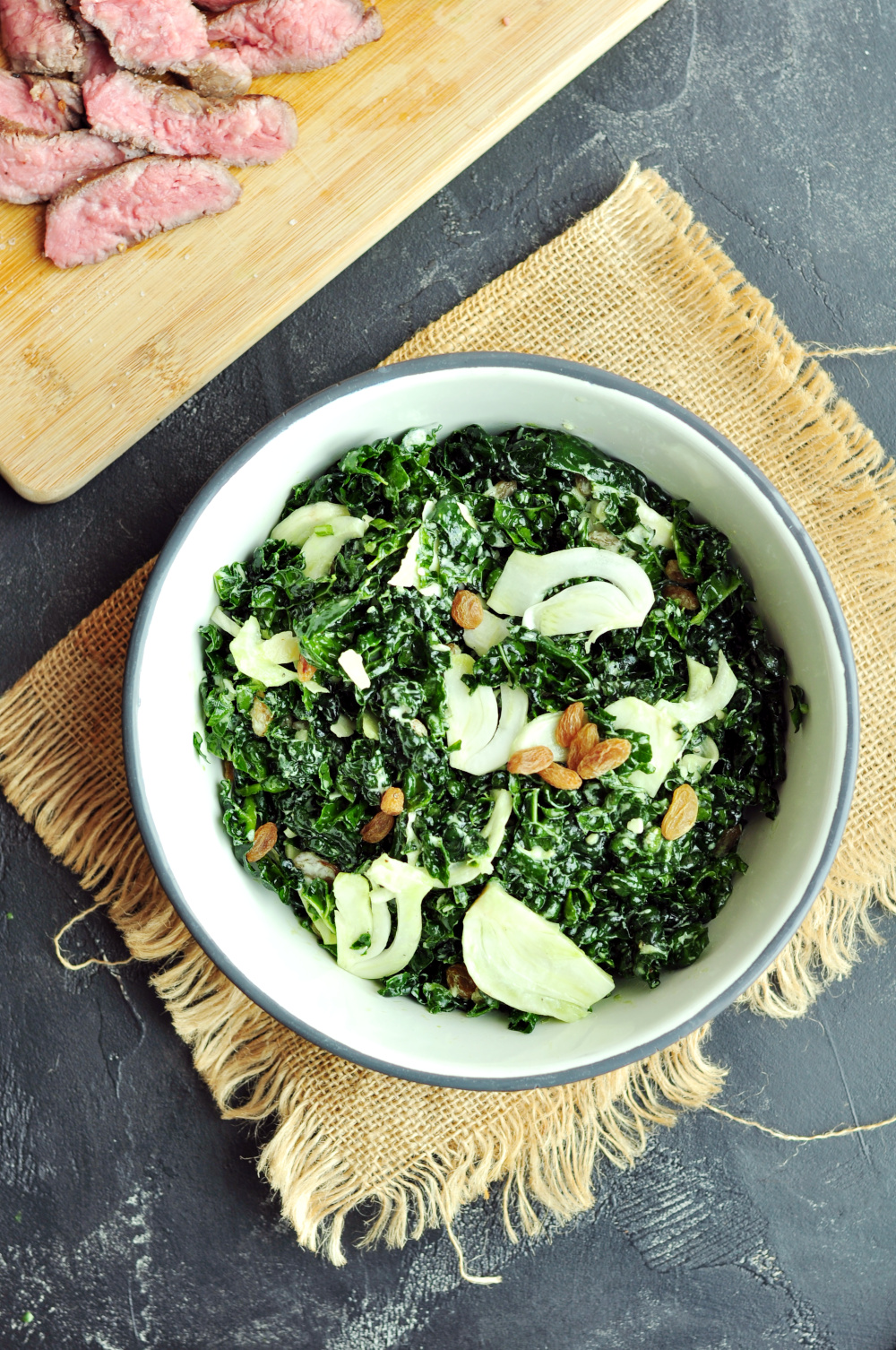 Kale Fennel Salad with a creamy garlic yogurt sauce, crisp fennel, sweet raisins, and shaved Parmesan — a flavor-packed salad ready in 15 minutes.