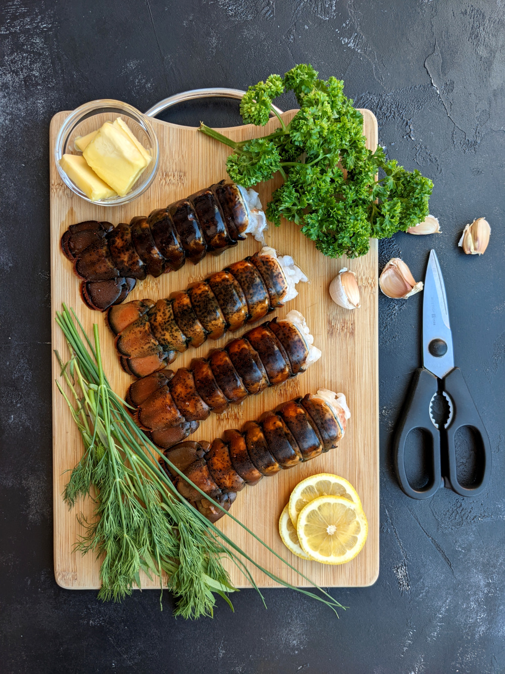 Four lobster tails, butter, lemon, garlic, and herbs