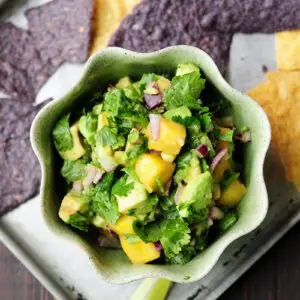 Refreshingly tasty mango avocado salsa that's a crowd-pleasing snack or appetizer with tortilla chips and it's amazing as a topping for seafood.
