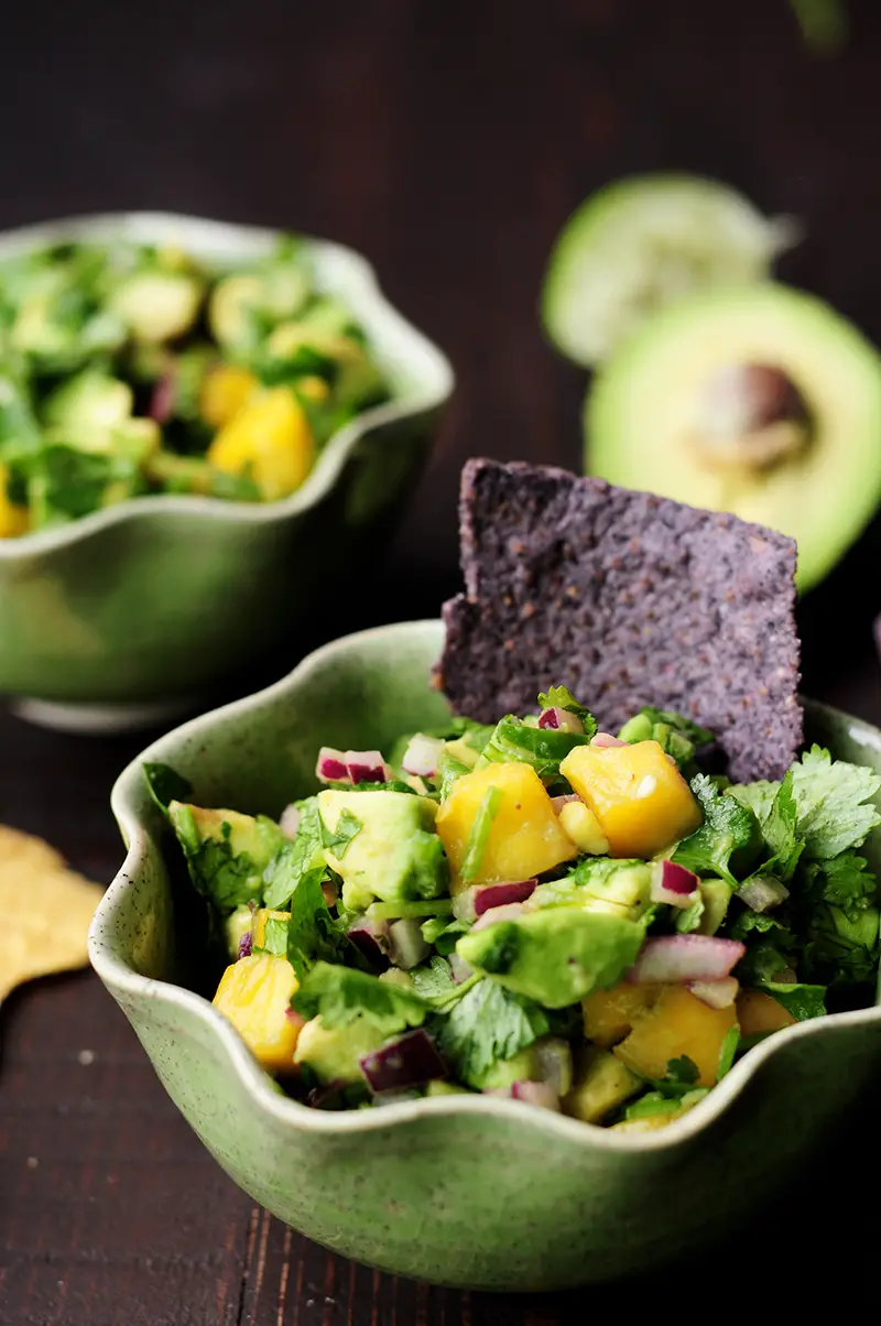 Refreshingly tasty mango avocado salsa that's a crowd-pleasing snack or appetizer with tortilla chips and it's amazing as a topping for seafood.