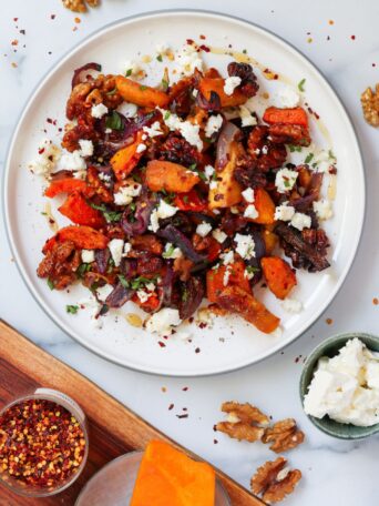 This maple-roasted pumpkin with chili and feta is the perfect sweet, spicy, and savory side dish. Easy to make and guaranteed to be a crowd-pleaser at your holiday table!