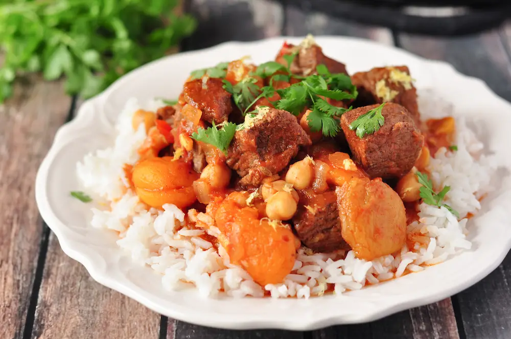 This gluten-free Moroccan lamb stew is made in 5 easy steps, and the slow cooker does the rest. Loaded with authentic spices and flavors. 