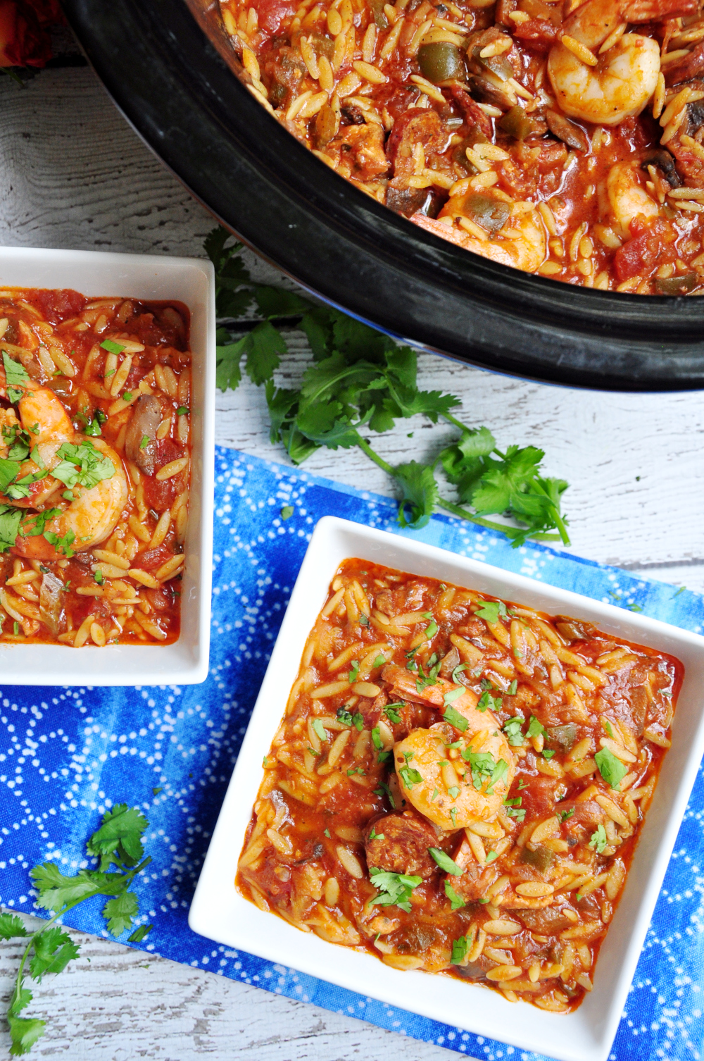 Dished one-pot jambalaya pasta featuring, Andouille sausage, chicken, shrimp, loads of veggies, and oval-shaped orzo pasta.