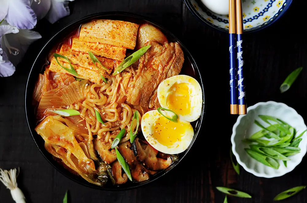 This epic kimchi ramen features pork belly, shiitake mushrooms, bok choy, tofu, and kimchi! The best part is that it's one pot and only takes 30 minutes!