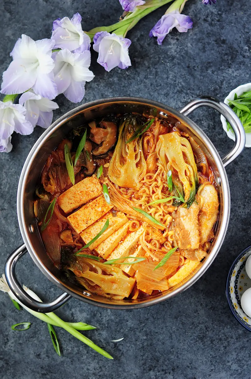 This epic kimchi ramen features pork belly, shiitake mushrooms, bok choy, tofu, and kimchi! The best part is that it's one pot and only takes 30 minutes!