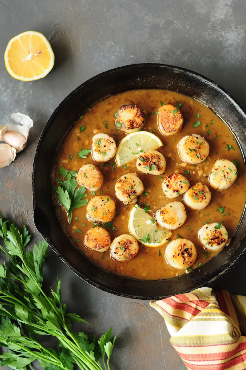 Perfectly pan-seared scallops served with a lemon butter sauce... this scallop recipe is the easiest gourmet dish you can make on a weeknight in just 15 minutes.