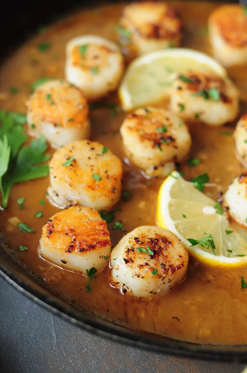 Perfectly pan-seared scallops served with a lemon butter sauce... this scallop recipe is the easiest gourmet dish you can make on a weeknight in just 15 minutes.