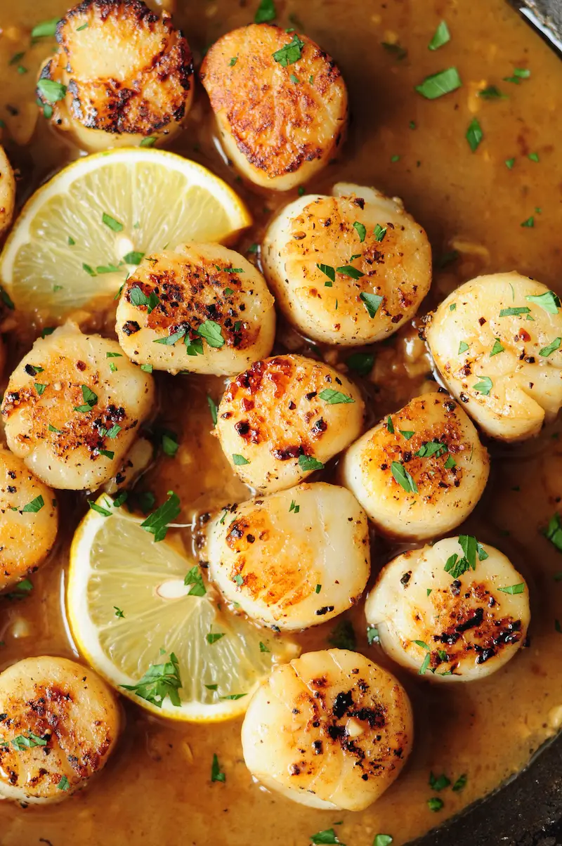 Perfectly pan-seared scallops served with a lemon butter sauce... this scallop recipe is the easiest gourmet dish you can make on a weeknight in just 15 minutes.