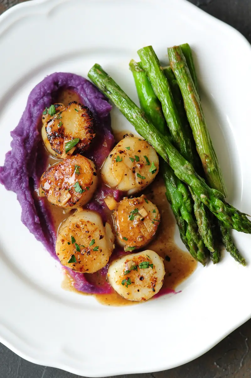 Perfectly pan-seared scallops served with a lemon butter sauce... this scallop recipe is the easiest gourmet dish you can make on a weeknight in just 15 minutes.