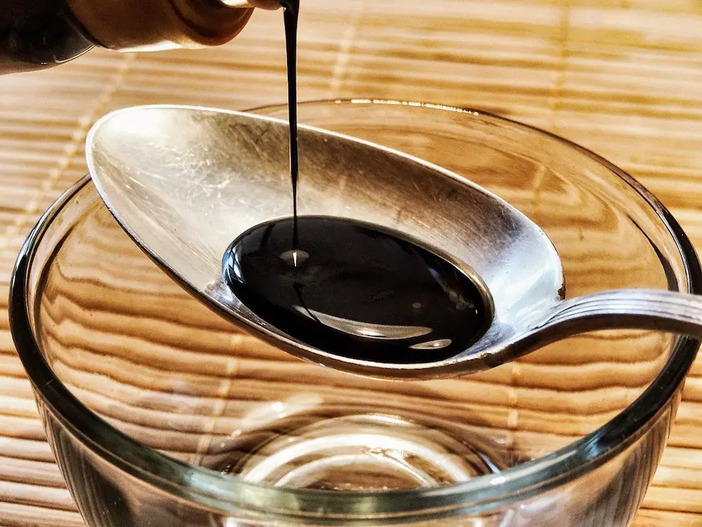 Pouring soy sauce into a spoon