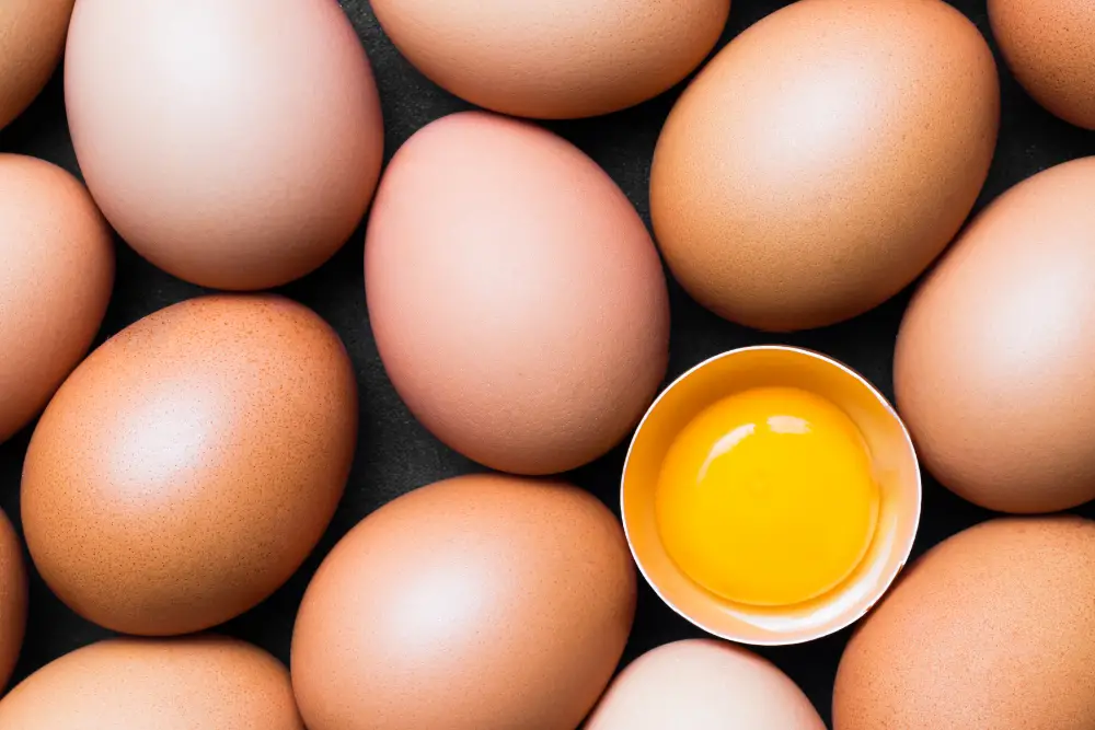  raw eggs with one cracked open