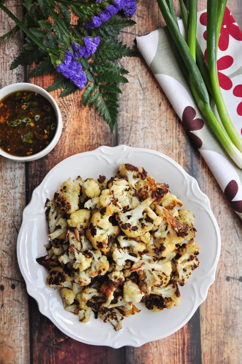 Say goodbye to bland and boring cauliflower. This roasted Asian cauliflower with a soy-ginger sauce is healthy, hearty, and a vegan crowd-pleaser. 