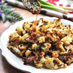 Oven-roasted Asian cauliflower that's delicious by itself, but even more intriguing with a savory soy-ginger sauce. Vegan and gluten-free friendly.