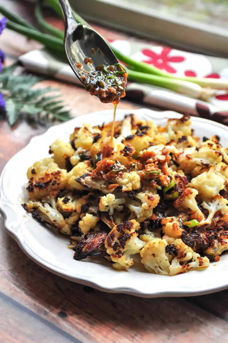 Say goodbye to bland and boring cauliflower. This roasted Asian cauliflower with a soy-ginger sauce is healthy, hearty, and a vegan crowd-pleaser. 