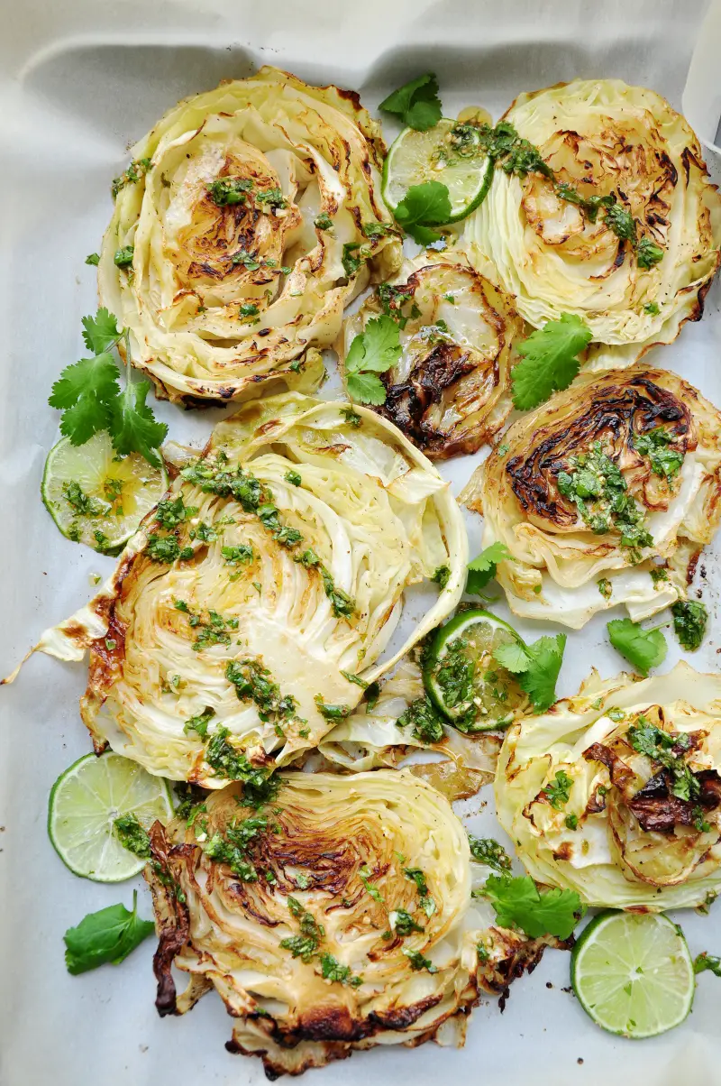 These roasted cabbage steaks drizzled with a refreshing cilantro lime sauce to intensify the flavor satisfy both vegetarians and meat-eaters alike.