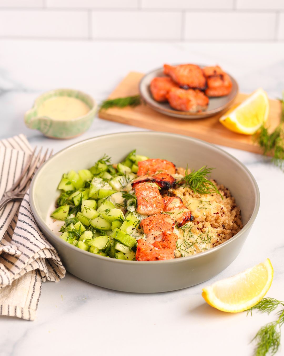 Whip up a healthy Salmon Quinoa Bowl in 30 minutes or faster with sous vide meal prep. This gluten-free, dairy-free recipe features honey-paprika salmon, a fresh cucumber salad, and a zesty sauce, all coming together to create a perfectly balanced meal.