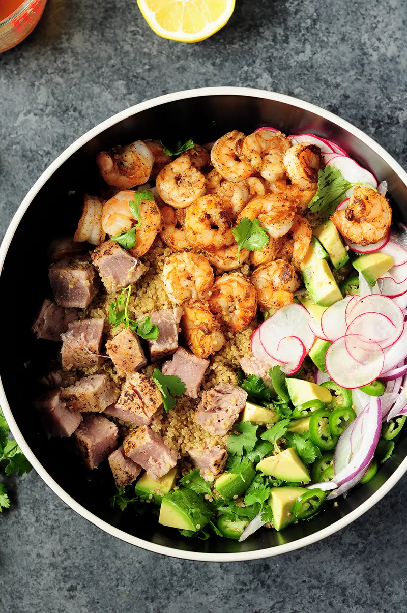 Colorful and delicious seafood quinoa salad made with nutritious chicken bone broth is the perfect light meal for a busy weeknight dinner.