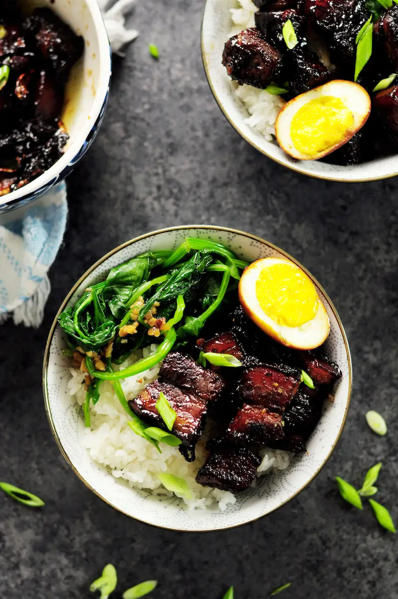 Authentic Shanghai-style braised pork belly simmered in rich and dark soy sauce and Chinese cooking wine, caramelized with brown sugar along with fresh ginger, garlic, green onion, and star anise. This is a true Chinese dish you can make in your own kitchen.