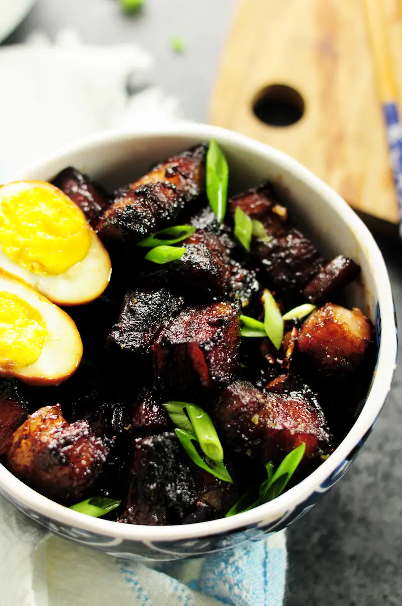 Authentic Shanghai-style braised pork belly simmered in rich and dark soy sauce and Chinese cooking wine, caramelized with brown sugar along with fresh ginger, garlic, green onion, and star anise. This is a true Chinese dish you can make in your own kitchen.