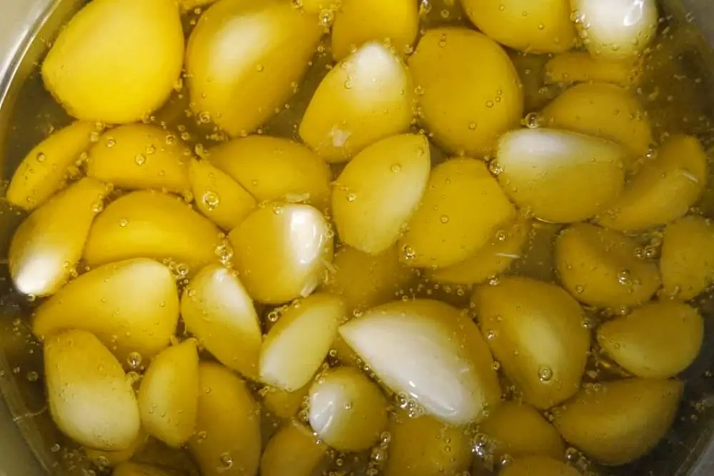 Simmer garlic in olive oil