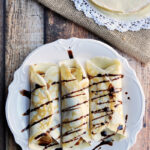 Simple crepes made from scratch and filled with peanut butter and banana then drizzled with chocolate syrup.