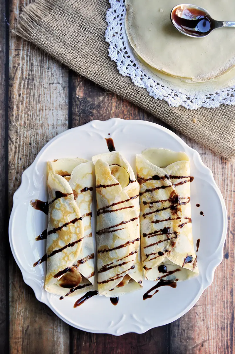 Simple crepes made from scratch and filled with peanut butter and banana then drizzled with chocolate syrup.