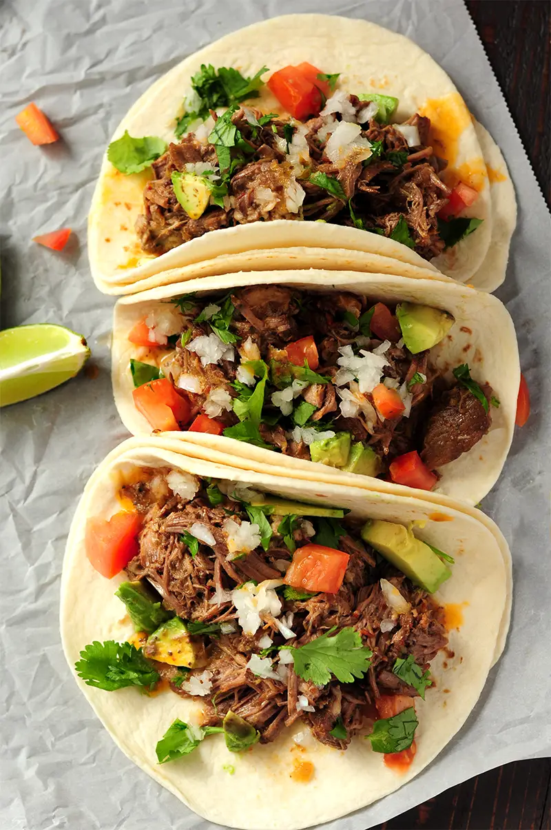 This beef barbacoa recipe takes five minutes of hands-on time and will yield the best tasting, melt-in-your-mouth-tender tacos you’ve ever made at home.