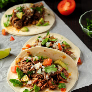 Extremely tender beef barbacoa slow-cooked in a super savory sauce. This recipe only takes 5 mins of hands-on time. Enjoy barbacoa tacos anytime!