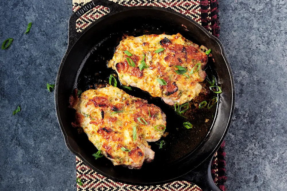 Baked pork chops covered in a smoky bacon and cheese mixture, with a simple vegetable slaw, you can wrap up this gluten-free and low-carb meal in 2